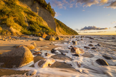 Beach and cliff in the Wolin National Park in the light of the wonderful sunsetの写真素材