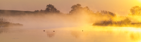 misty, fairytale sunrise over the lakeの写真素材