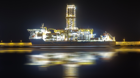 oil rig in the harbor at nightの写真素材