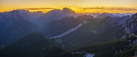 Panorama of the Julian Alps at sunset from the Mangart peak, the Triglav peak visible in the central part of the frameの写真素材