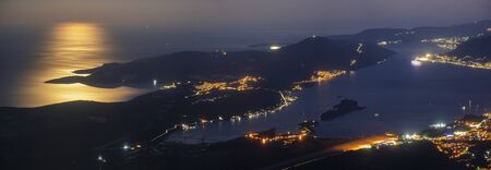 Kotor Bay in Montenegro at night in full moon light. Kotor lights visibleの写真素材