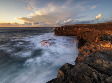 beautiful and dramatic sunset on a craggy rocky cliff, Jandia Peninsula, Fuertaventura