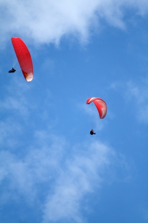 two para gliders on blue sky backgroundの写真素材