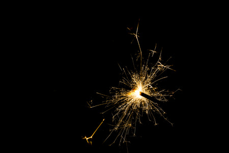 a sparkler on isolated on a  black backgroundの写真素材