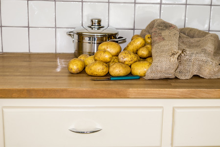 old fashion kitchen with potatos in gunny bag and coocking potの写真素材