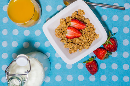 healthy breakfast, with muesli,vintage milk bottle, strawberries and orange juice,