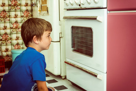 kid in a vintage kitchen looking if the cookies are ready,vintage filter added