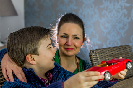 boy showing his model car to his mother, shallow depth of fieldの写真素材