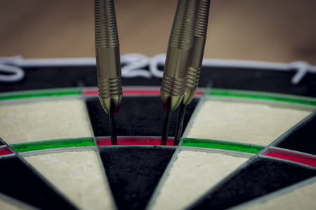dart board with three darts in the triple twenty area.の写真素材