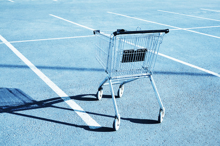Shopping cart in a store parking lot. Blue toningの写真素材