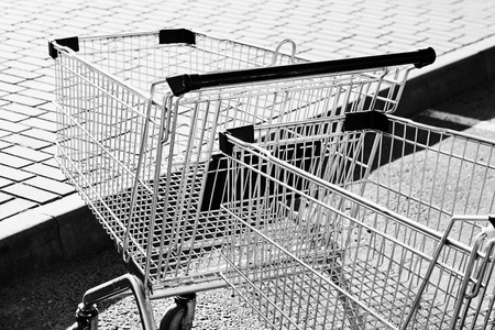 Two Shopping carts in a store parking lot. Black and whiteの写真素材