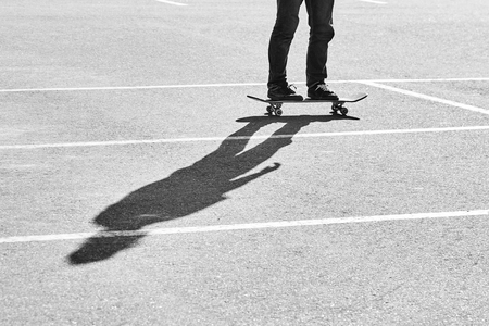 Shadow of a skateboarder on asphalt. Black and white imageの写真素材