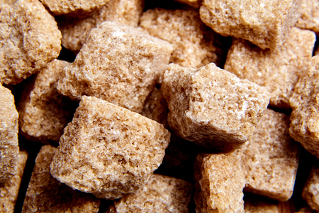 Heap brown cane unrefined sugar cubesの写真素材
