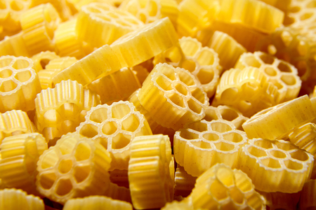 Raw uncooked Rotelle dry italian pasta. Ruote, wagon wheel shapedの写真素材