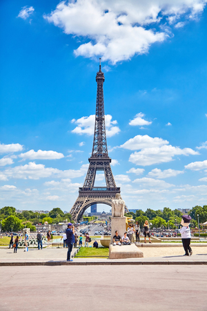 Paris, France - June 19, 2015: View of the bridge over the River Seine and the Eiffel Tower on a summer sunny day. Tourists are photographed against the backdrop of attractionsのeditorial素材