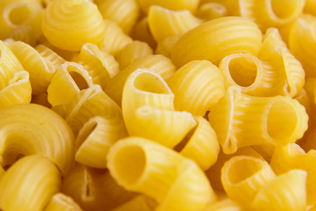 Raw uncooked dry italian Gomiti pasta Elbow Macaroniの写真素材