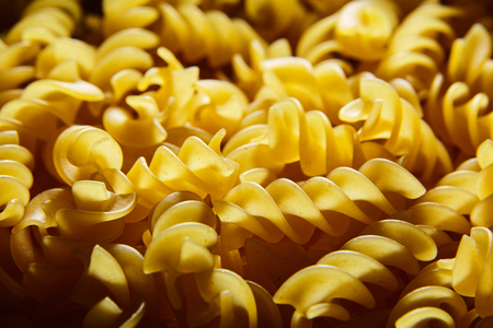 Raw uncooked dry italian fusilli pasta. Corkscrew spiral shapeの写真素材