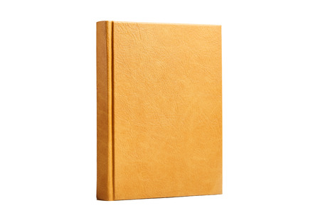 The book is in a bright brown hard leather cover. Isolated on white backgroundの写真素材