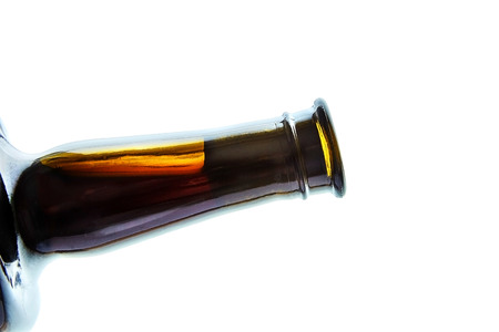 corked glass bottle of red wine at the lumen, side view, isolated on white backgroundの写真素材