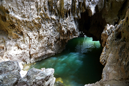 Cave in rock filled with river water. Glare on the stone surface of the mainsail. reflection of liquid on the wall of grottoの写真素材