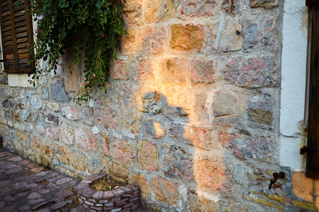shadow of a kissing couple in love on an old stone wallの写真素材