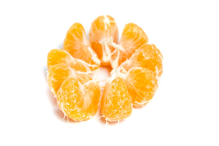 Peeled segments of tangerine or mandarin citrus fruit isolated on white backgroundの写真素材