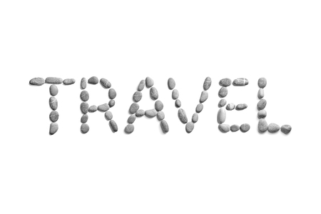 Pebbles on white background, sea pebble. Inscription, text, word: TRAVELの写真素材