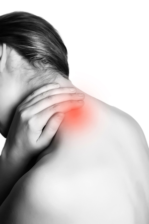Rear view of a women holding her neck in pain. isolated on white background. monochrome photo with red as a symbol for the hardening. Health conceptの写真素材