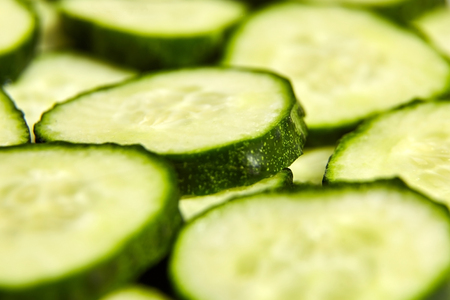 Green slices of cucumber as backgroundの写真素材
