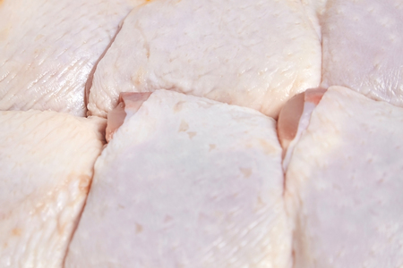Raw chicken thighs with skin. Meat of poultry backgroundの写真素材