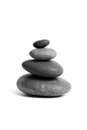 Stacked smooth grey stones. Sea pebble. Balancing pebbles isolated on white backgroundの写真素材