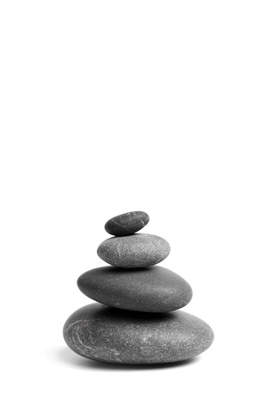 Stacked smooth grey stones. Sea pebble. Balancing pebbles isolated on white backgroundの写真素材