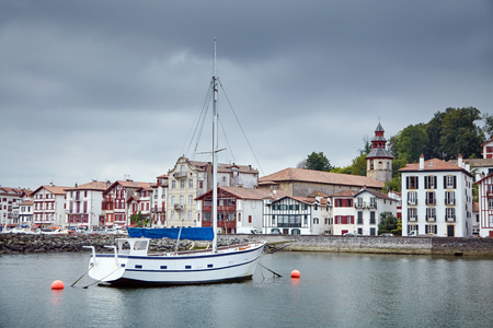 White Sailing yacht moored in the fishing port of Saint-Jean-de-Luz / Ciboure (France)の写真素材