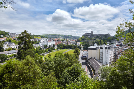 Lourdes, France: Chateau Fort of Lourdes and roofs of buildings. French city is located in the foothills of the Pyrenees mountainsの写真素材