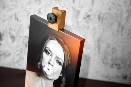 Photography printed on canvas with gallery wrap. Portrait of a beautiful young woman. Wooden easel...