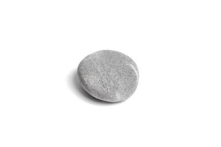 Single grey pebble isolated on white background. Smooth gray sea stone