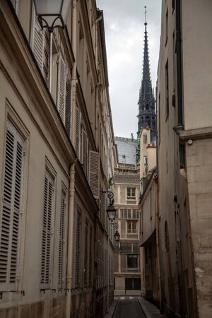 Spire of Notre Dame de Paris Cathedral before fire. Old narrow street in Paris, France, Europeの写真素材