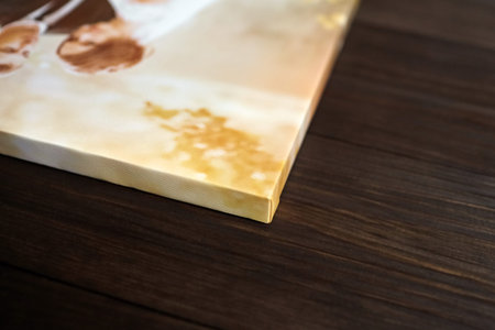 Photo canvas print. Sample of stretched photography with gallery wrapping on a wooden stretcher bar. Lateral side view, closeup. Selective focusの写真素材