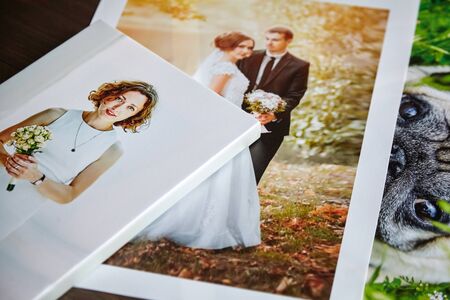Photo canvas prints. Sample of stretched photography of woman with gallery wrap. Printed photos of a dog and a wedding couple lying on a tableの写真素材