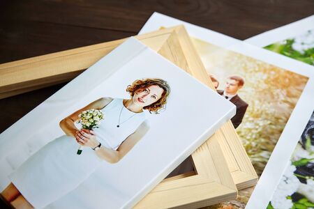 Photo canvas prints. Sample of stretched photography of woman with gallery wrap. Printed photos of a dog and a wedding couple lying on a tableの写真素材