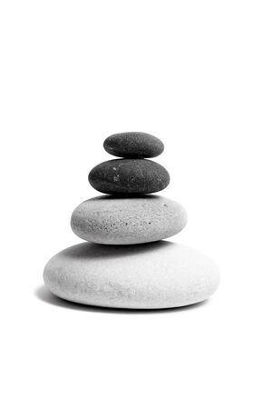 Stacked smooth grey stones. Sea pebble. Balancing pebbles isolated on white backgroundの写真素材