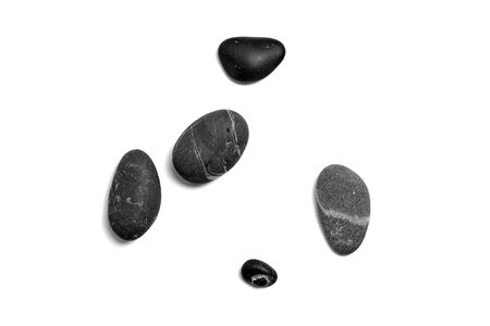 Scattered sea pebbles. Smooth gray and black stones isolated on white background. Top viewの写真素材