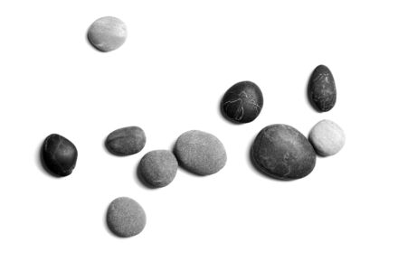 Sea pebbles. Heap of smooth gray and black stones isolated on white background, top viewの写真素材
