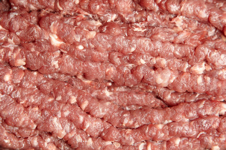 Ground beef texture background. Uncooked mincemeat. Forcemeat, fresh raw minced meat, top view