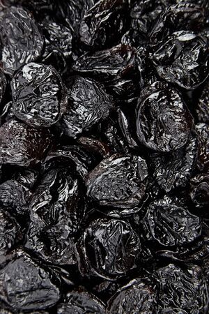 Prunes, many withered plums background, top view. Heap of dried fruitsの写真素材