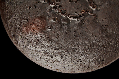 Chocolate pie brown surface, texture, black background, top view. Home cake with cocoa ingredient