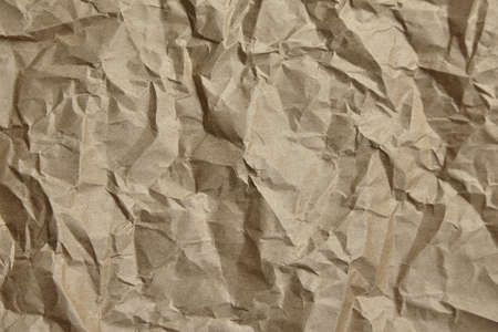 Crumpled paper, texture, background. Brown craft paper with wrinkled pattern, top viewの写真素材