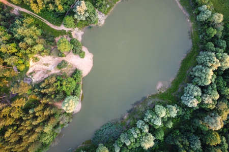 Aerial landscape view - small lake in the middle of forest. European nature.の写真素材