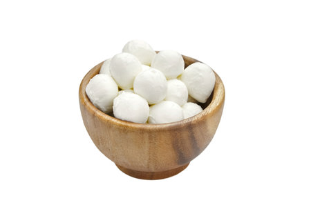 Wooden bowl full of small mozzarella cheese balls isolated on white background