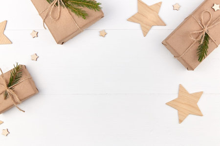 Christmas frame. Christmas gift boxes with decorations on wooden white background. Flat lay, top...